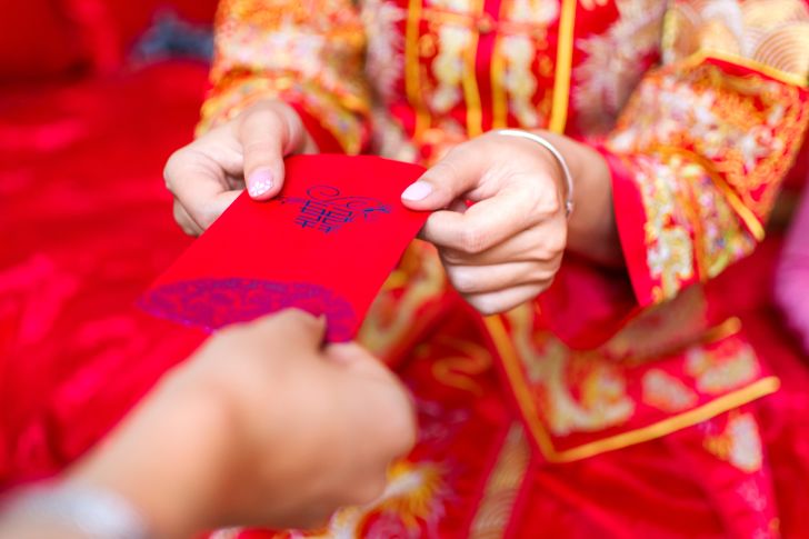 a person accepting a red envelope