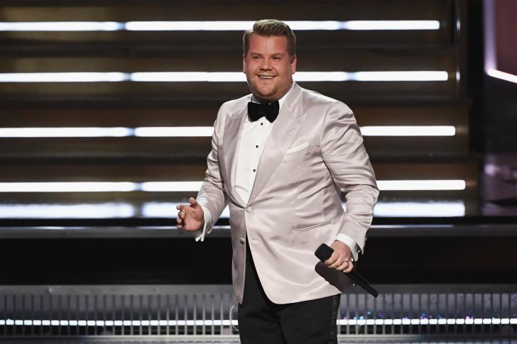 James Corden on stage in a white jacket