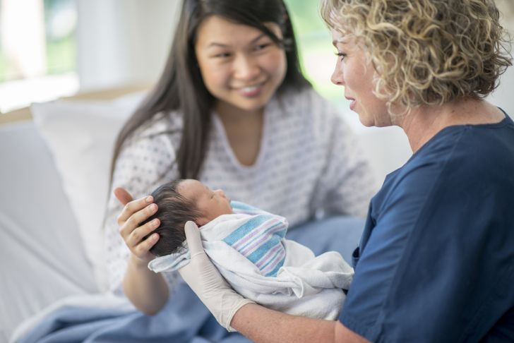 Nurse holding newborn