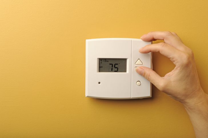 Thermostat on a yellow wall