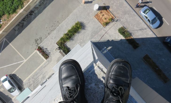 Feet on the edge of a building.