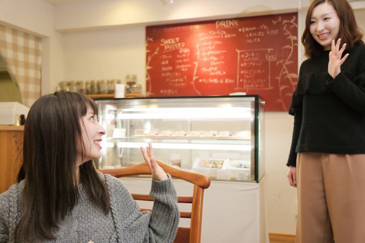 Women waving hello to each other