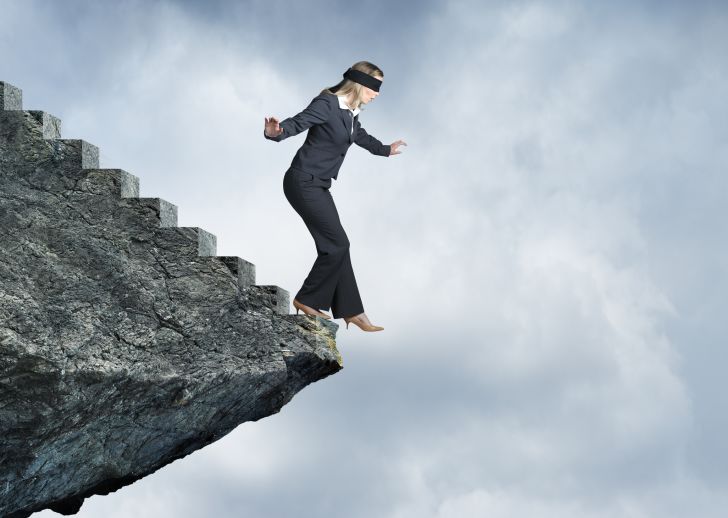 Blindfolded Businesswoman About To Step Off Cliff Stairs