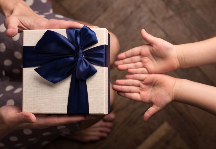 Mother giving a big gift boxes to child