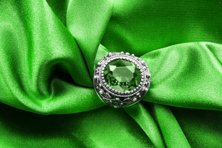 emerald ring on green satin