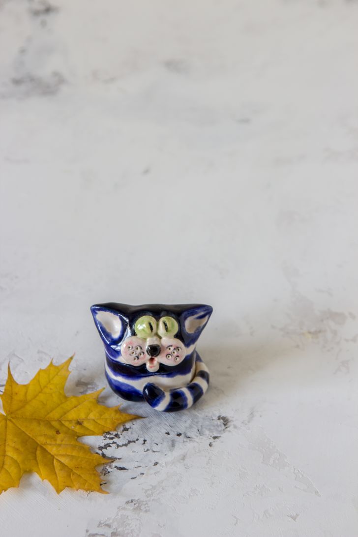 Porcelain cat figure and leaf