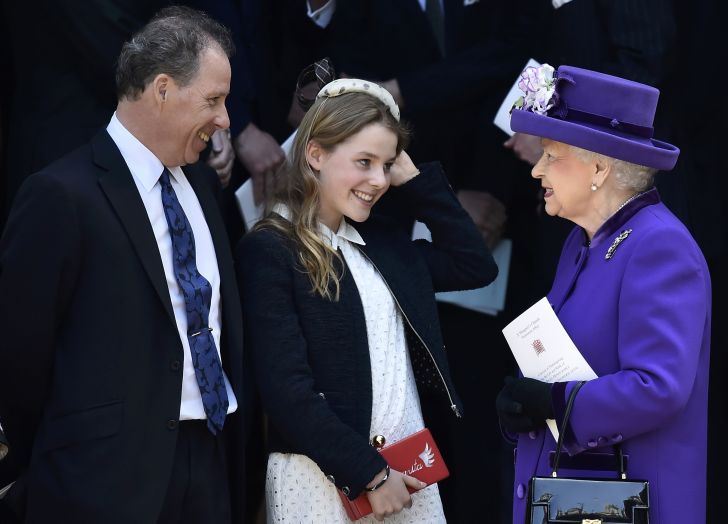 Britain's Queen Elizabeth II (R) talks with Lady Margarita Armstrong-Jones (C) as her father David Armstrong-Jones (L), 2nd Earl of Snowdon, known as David Linley