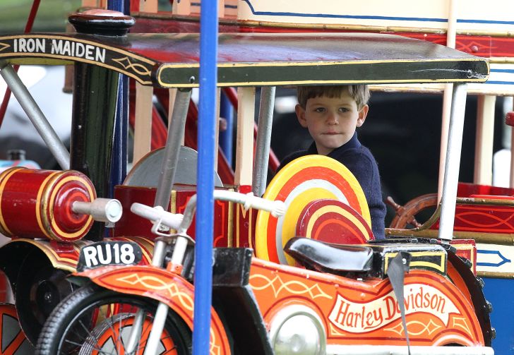 James, Viscount Severn, rides on the fun fair carousel on day 4 of the Royal Windsor Horse Show on May 11, 2013 in Windsor, England