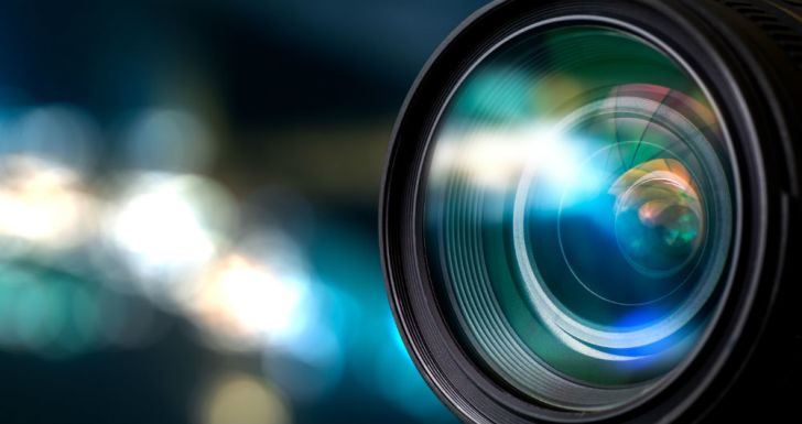 A camera lens is shown reflecting light