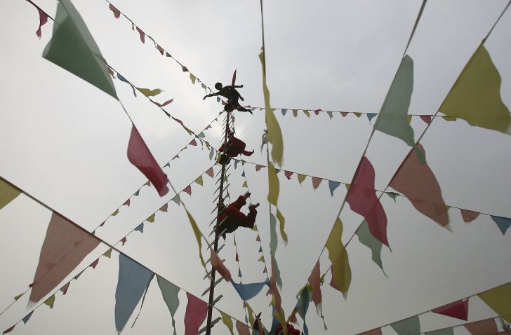 miao performers on traditional knife ladder