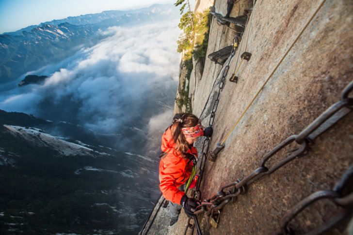 woman climbs mount huashan path