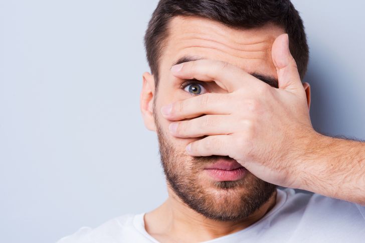 Man covering face
