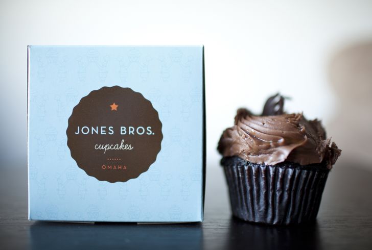 A Jones Bros Sweet and Salty cupcake next to a box.