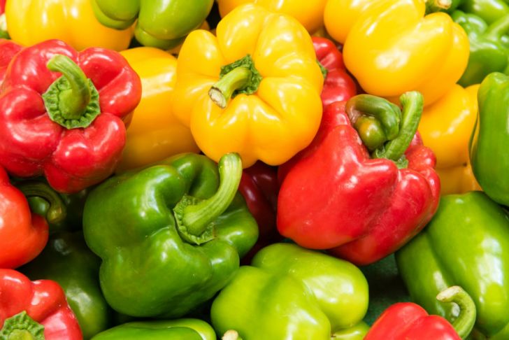 Bell peppers sit in a pile