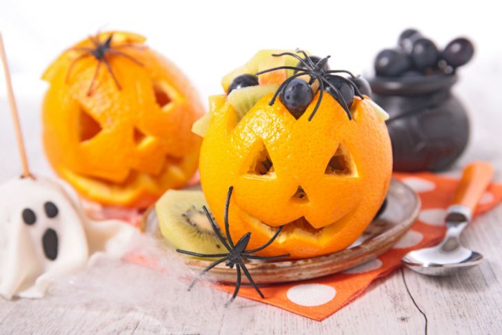 Oranges are cut into Halloween designs and stuffed with treats