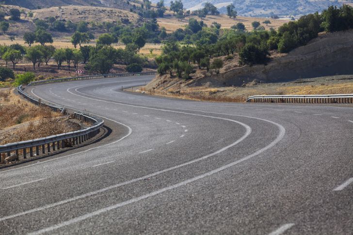 An empty, winding road in an S-shape