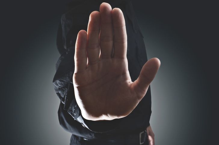 A close-up of a man's hand facing outward in a