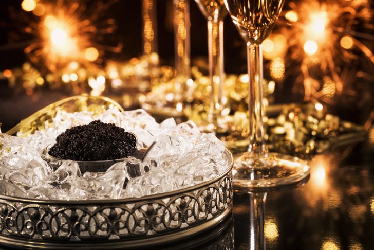A bowl of black caviar and flutes of champagne