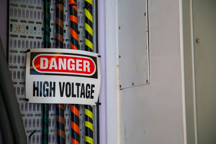 Electrical cables with a sign that says