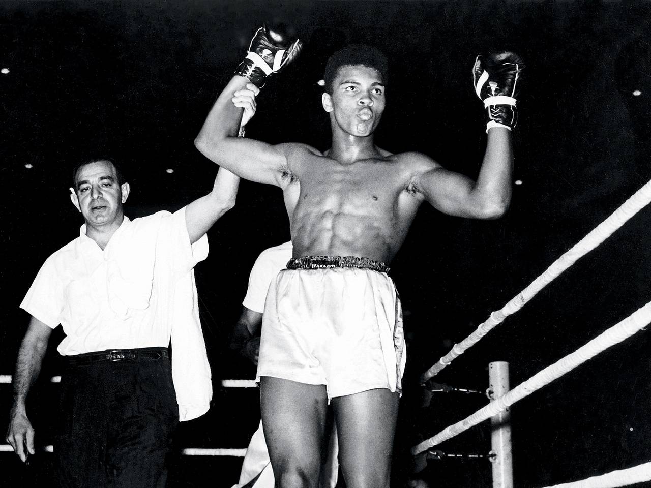 A referee raises Ali’s arm in victory