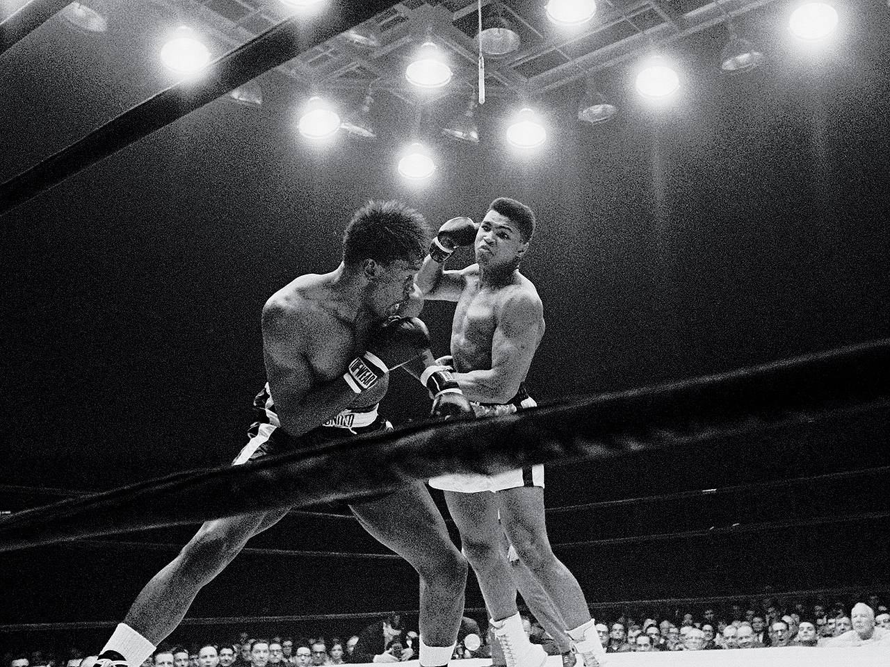 Ali and an opponent in a tight clinch