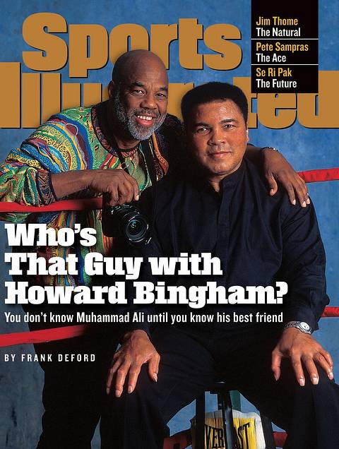 SI cover, July 13, 1998: "Who's That Guy with Howard Bingham? You don't know Muhammad Ali until you know his best friend." Photographer Howard Bingham, holding a camera, wraps an arm around a seated Ali in a boxing ring.