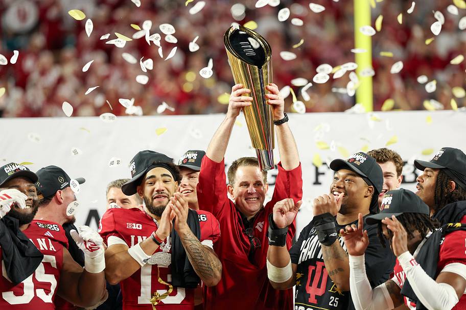 Curt Cignetti raises the 2025–26 national championship trophy.