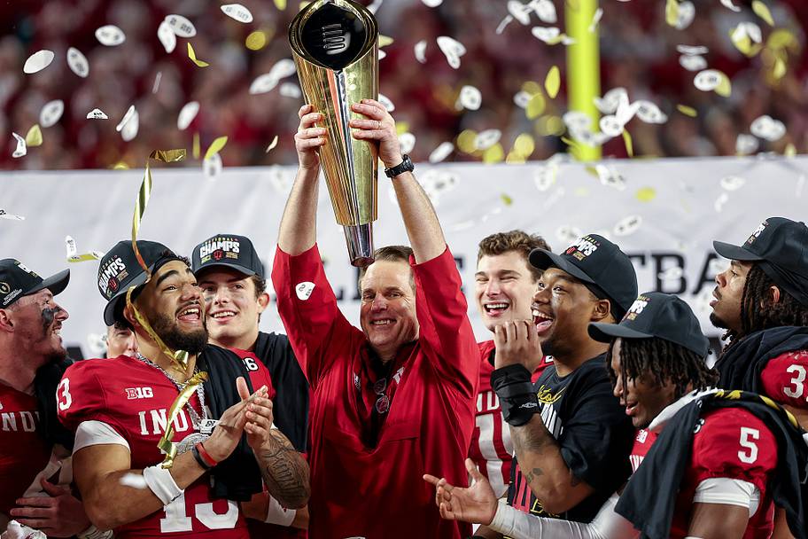 Indiana football coach Curt Cignetti raises the CFP trophy.