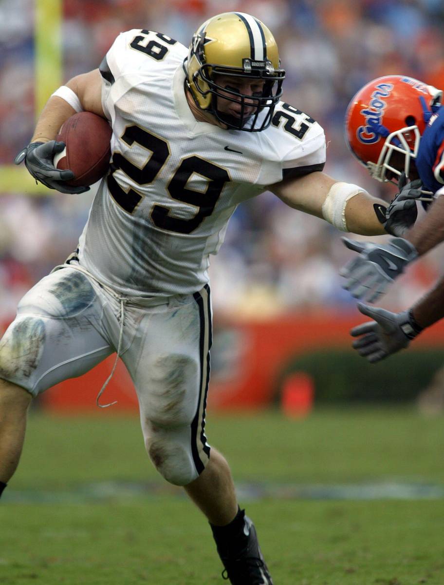 Vanderbilt fullback Clark Lea stiff-arms a player.