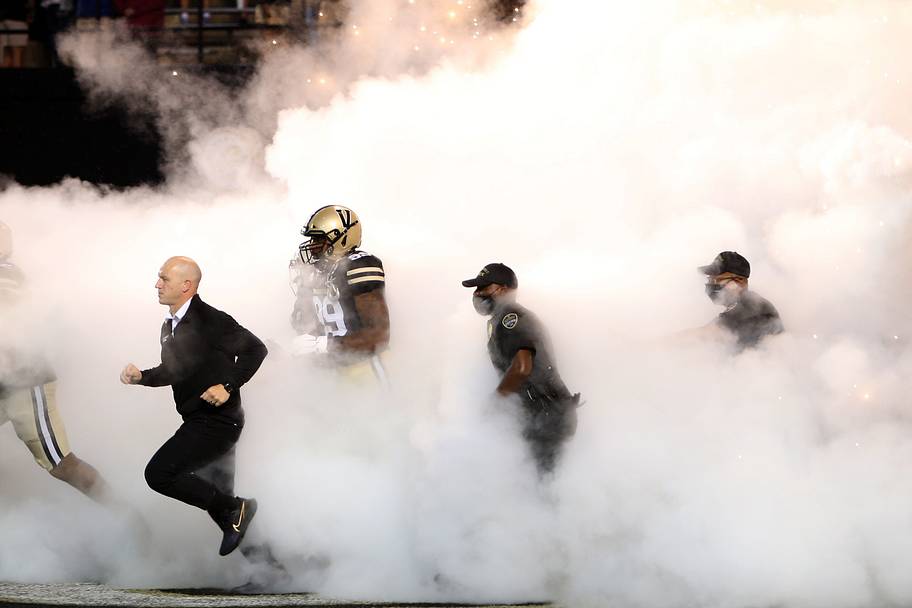 Clark Lea leads his team out onto the field before a game.