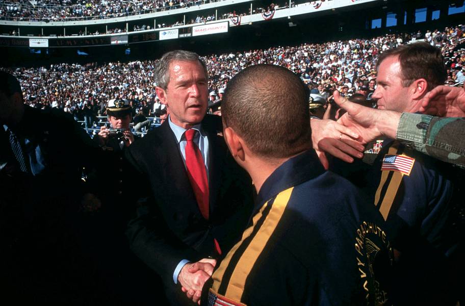 President George W. Bush meets with members of Navy and Army during their 2001 college football game.