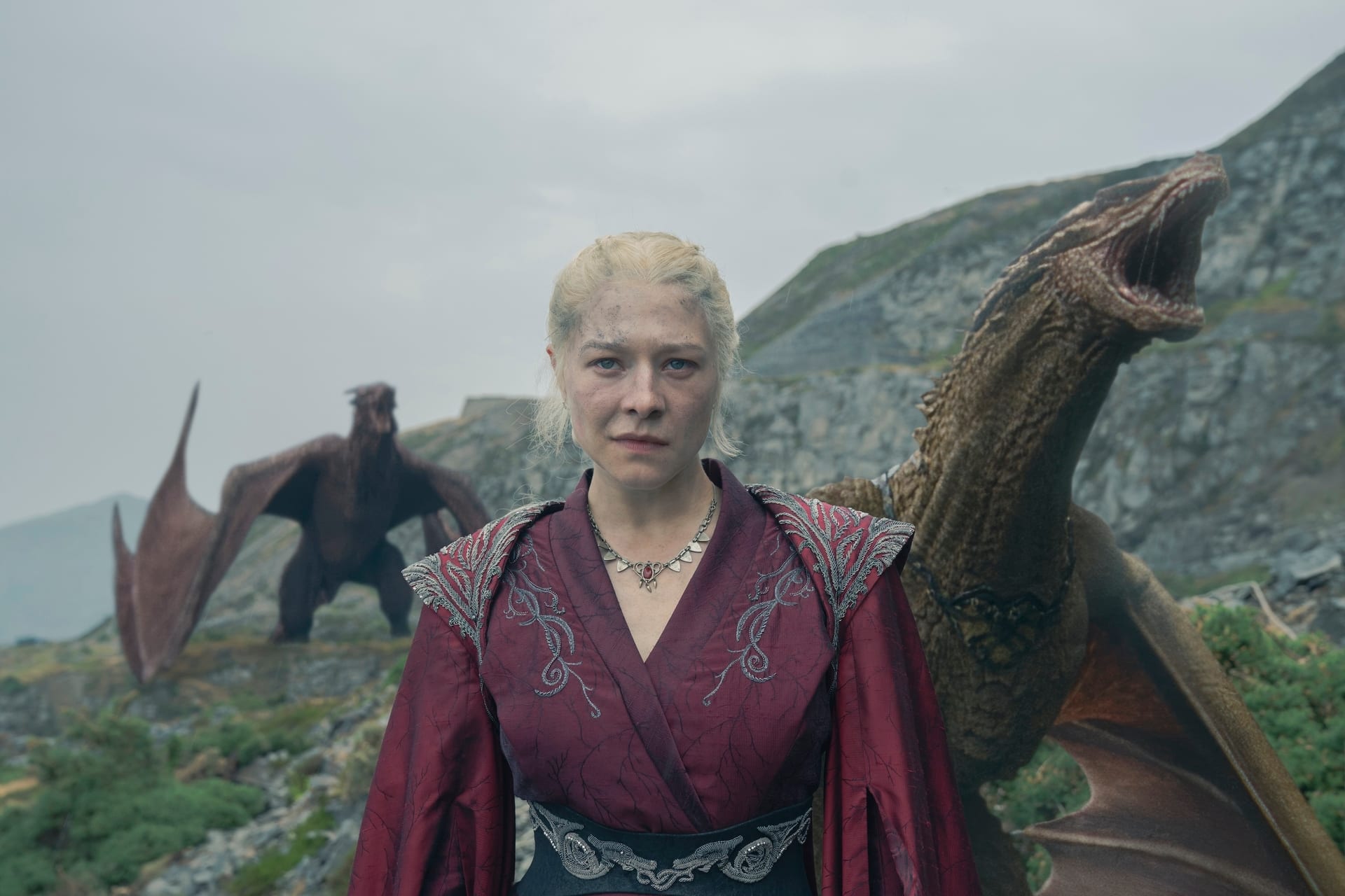 Rhaenyra Targaryen (Emma D'Arcy) standing with the dragons Syrax and Vermithor on Dragonstone in HBO's House of the Dragon.