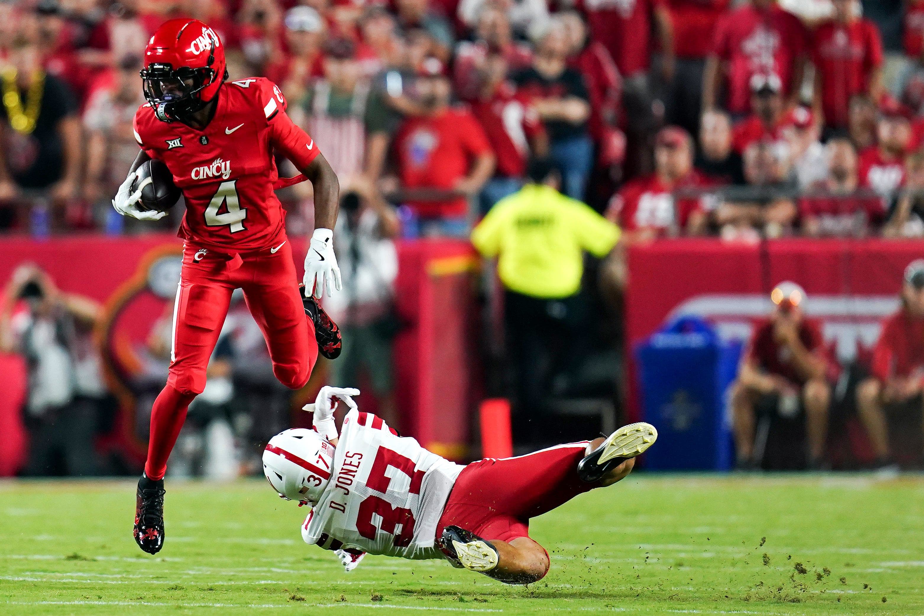 Cincinnati Bearcats wide receiver Cyrus Allen (4) dodges a tackle by Nebraska Cornhuskers defensive back Donovan Jones (37).