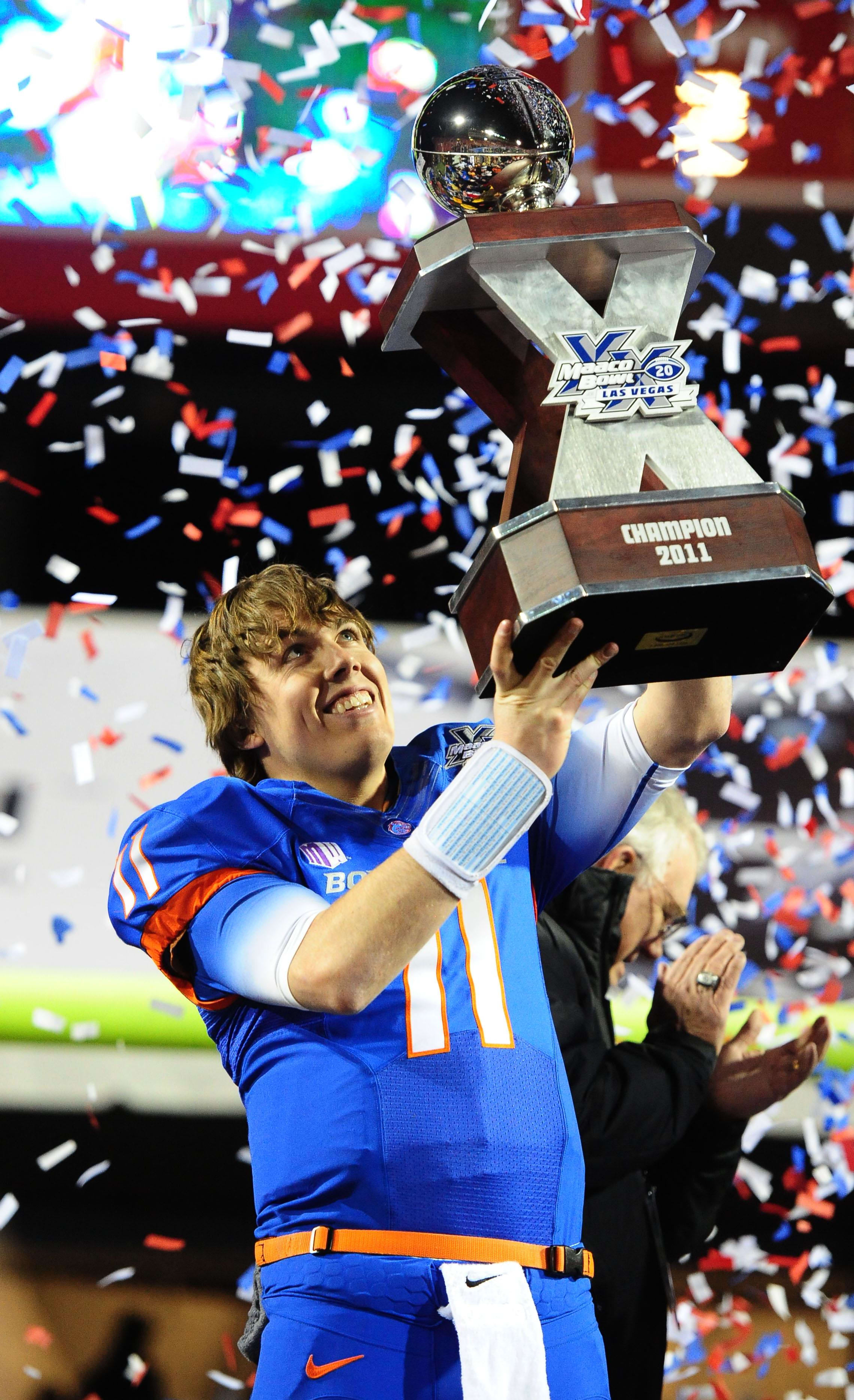Boise State Broncos quarterback Kellen Moore hoists the Las Vegas Bowl trophy after a win over the Arizona State Sun Devils.