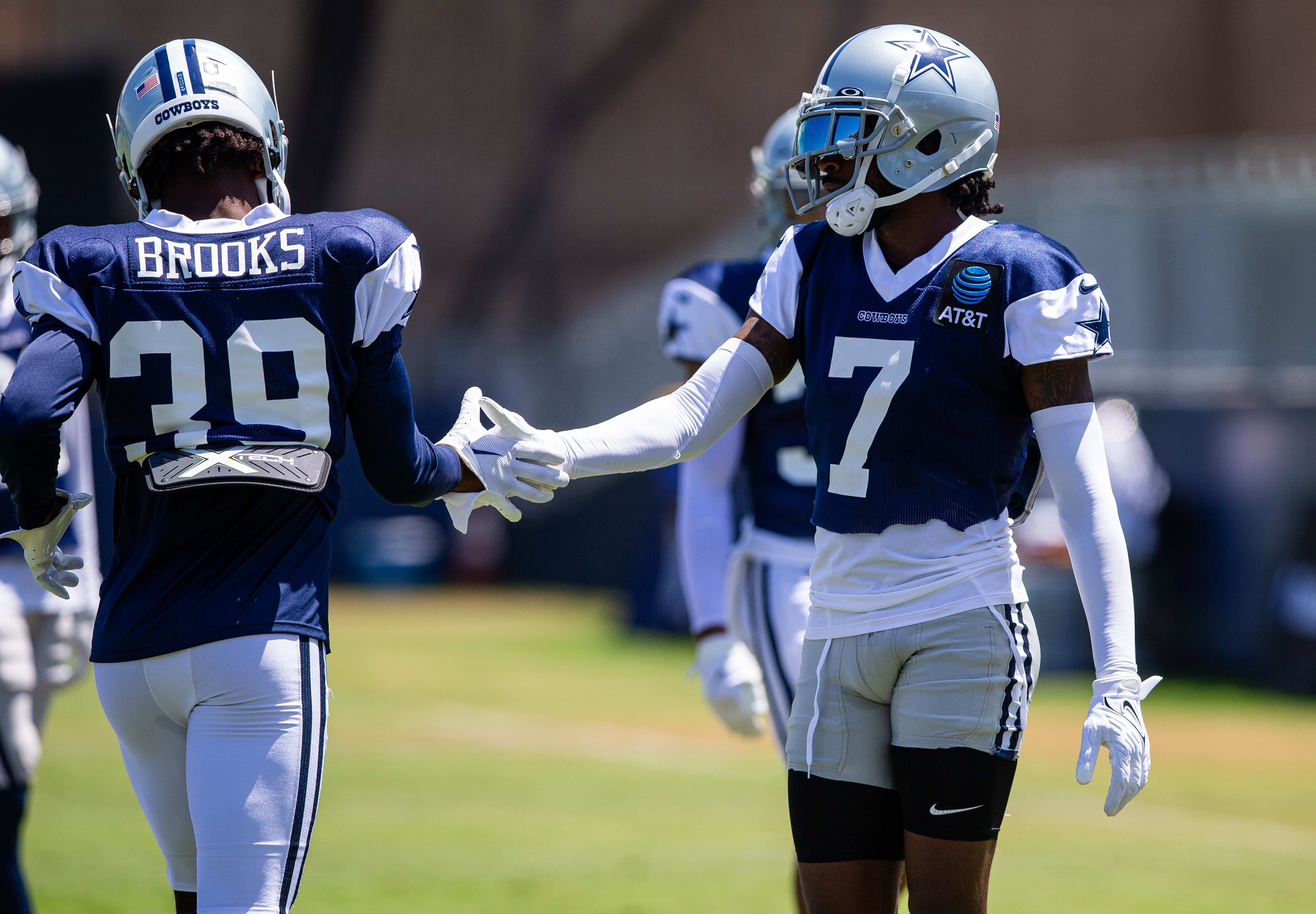 Dallas Cowboys cornerback Trevon Diggs (7) congratulates cornerback Myles Brooks (39) after a drill during training camp.