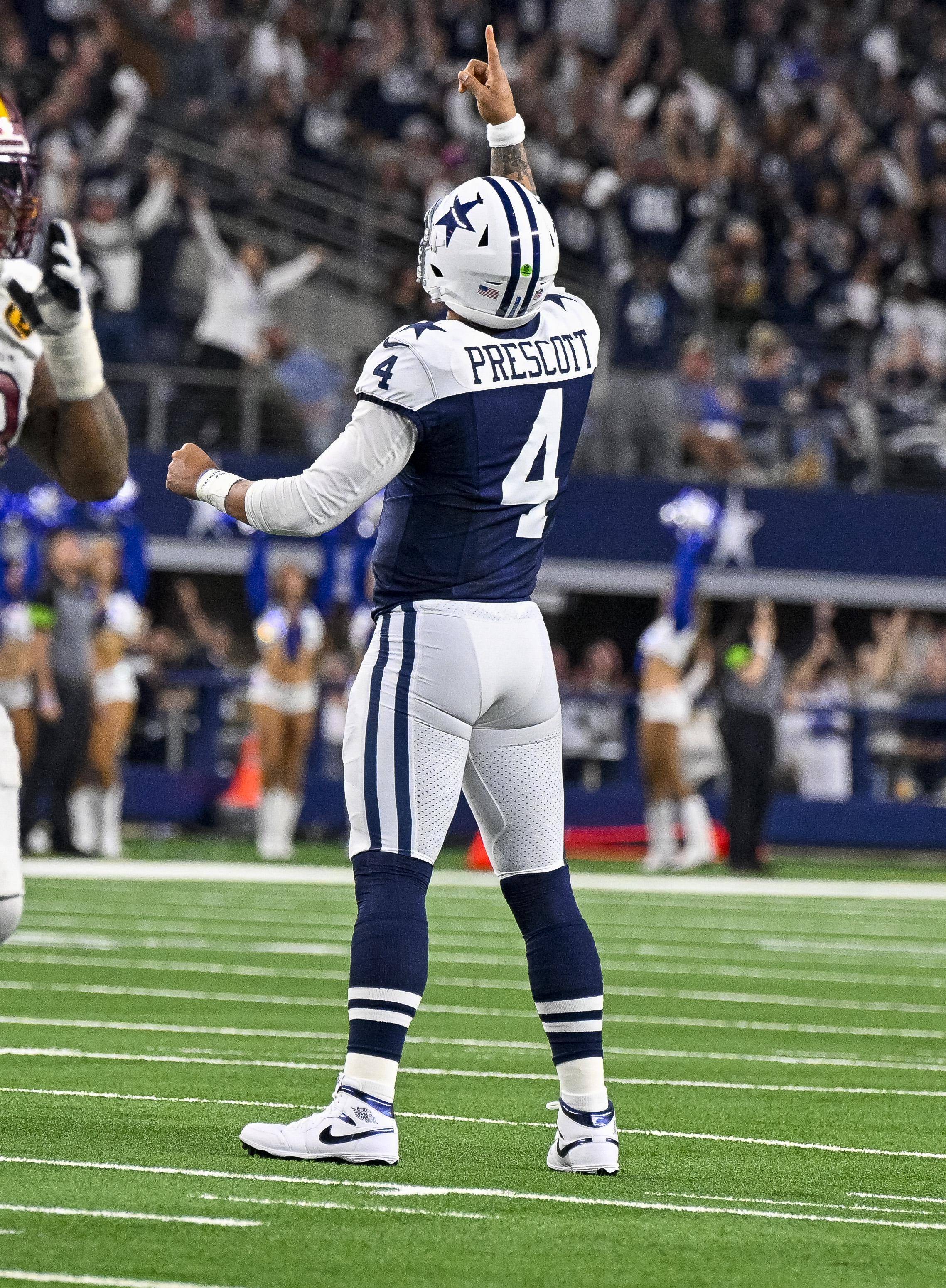 Dallas Cowboys quarterback Dak Prescott celebrates after throwing a touchdown pass against the Washington Commanders