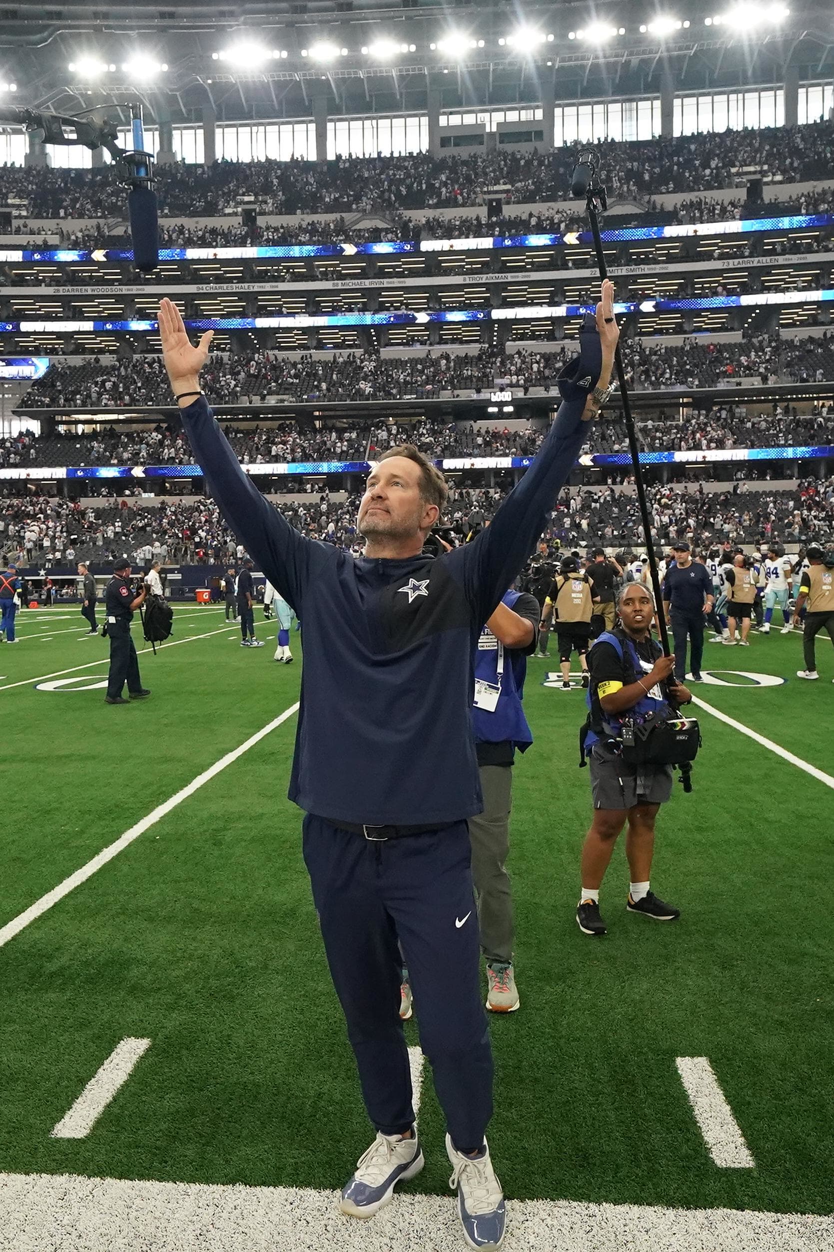 Dallas Cowboys head coach Brian Schottenheimer gestures to fans after the game against the New York Giants at AT&T Stadium 