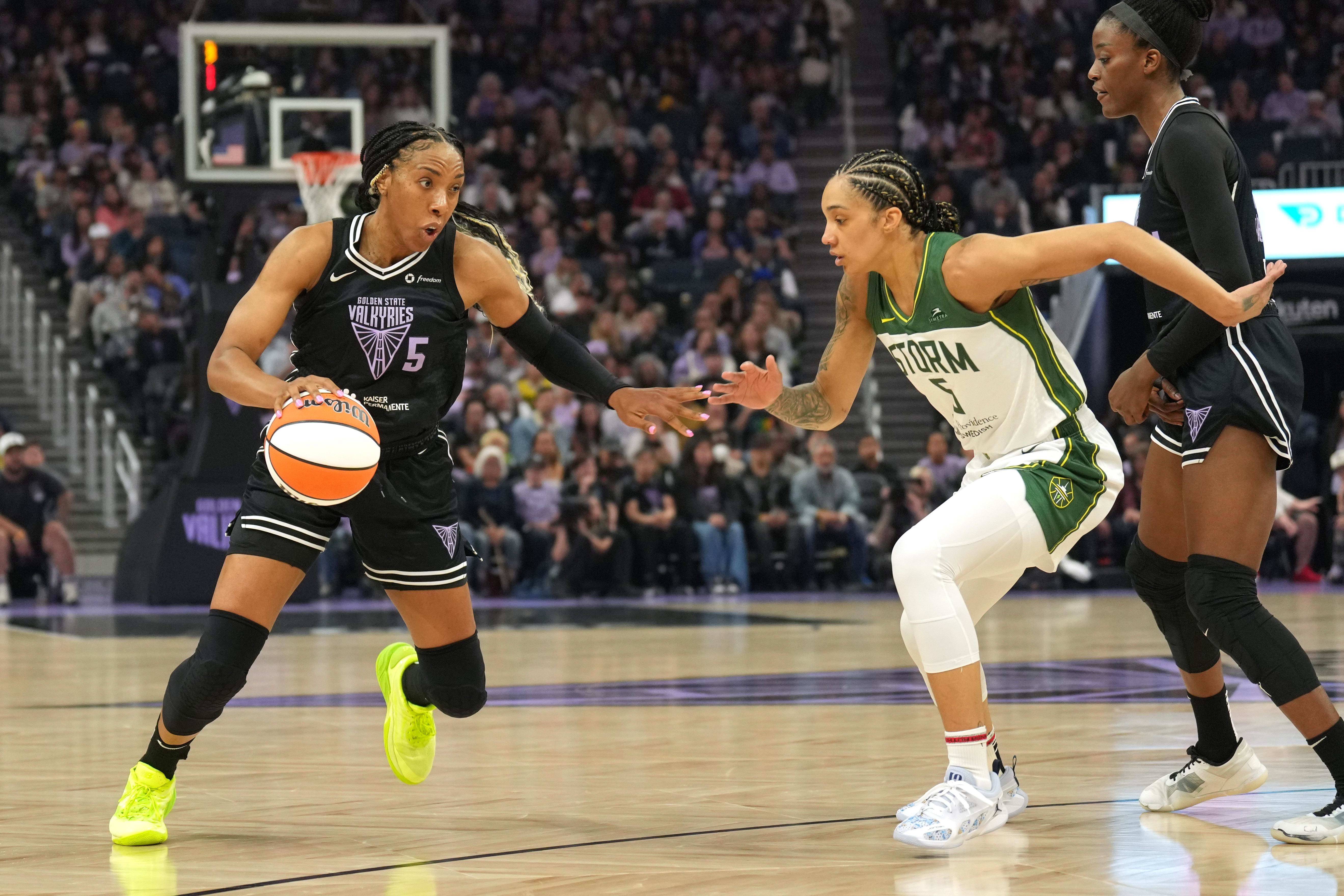 Golden State Valkyries forward Kayla Thornton, Seattle Storm forward Gabby Williams, and Valkyries center Temi Fagbenle