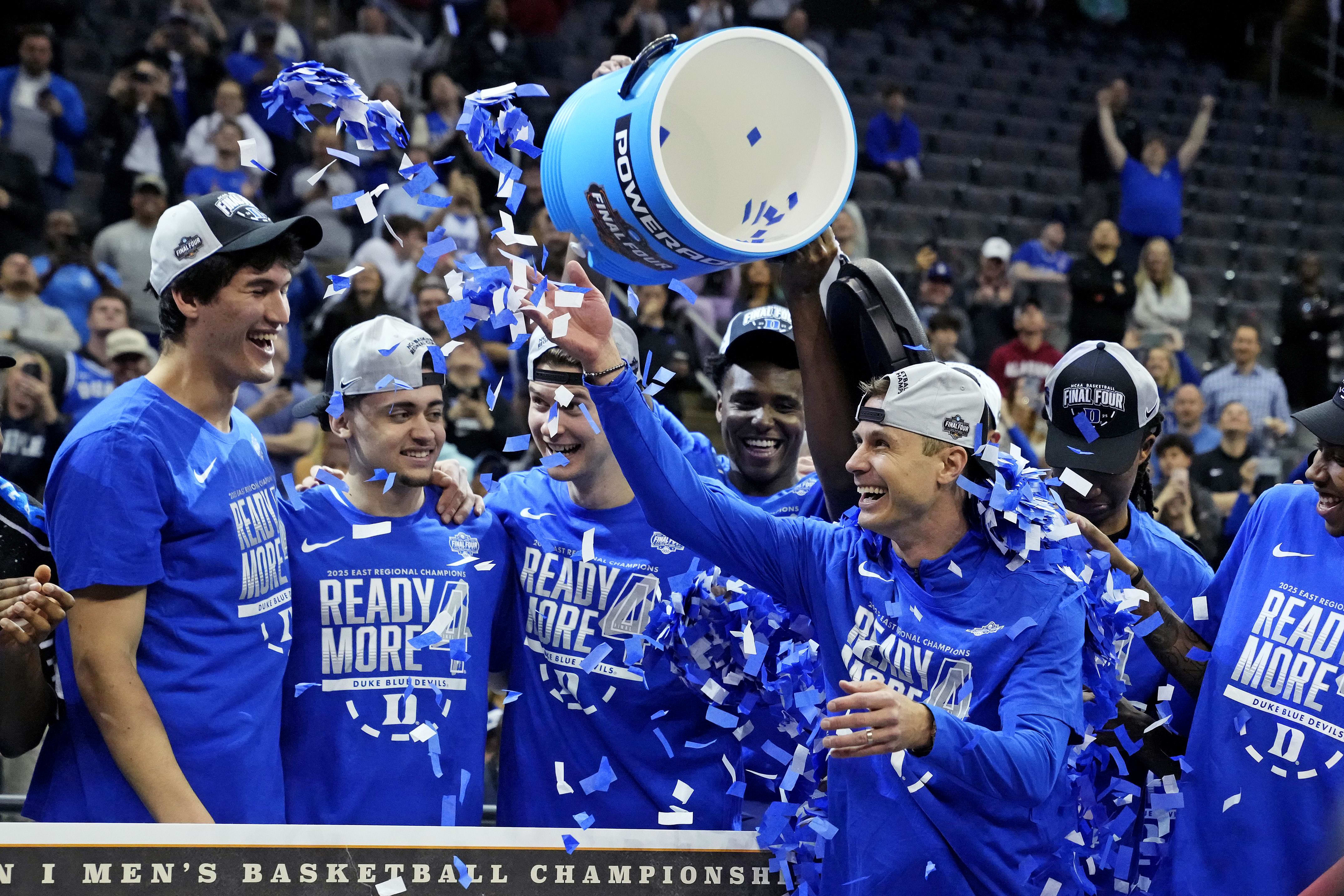 Scheyer celebrates with his team after winning the East Regional final.