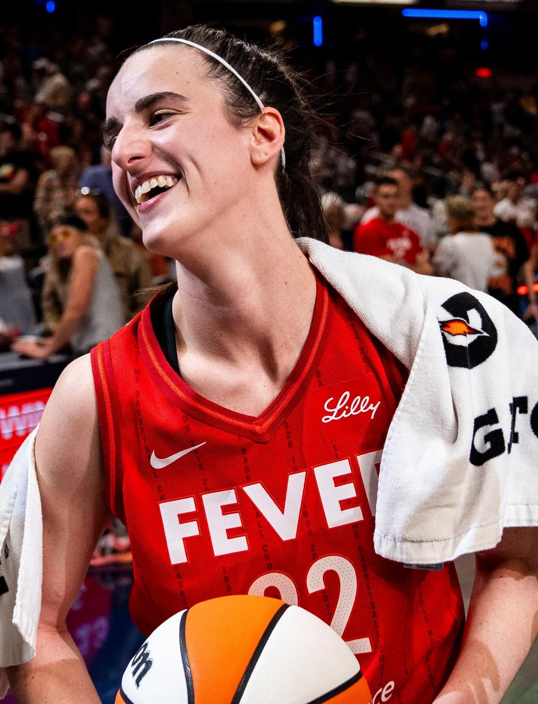 Indiana Fever guard Caitlin Clark smiles in an interview after becoming the first rookie to achieve a triple-double. 