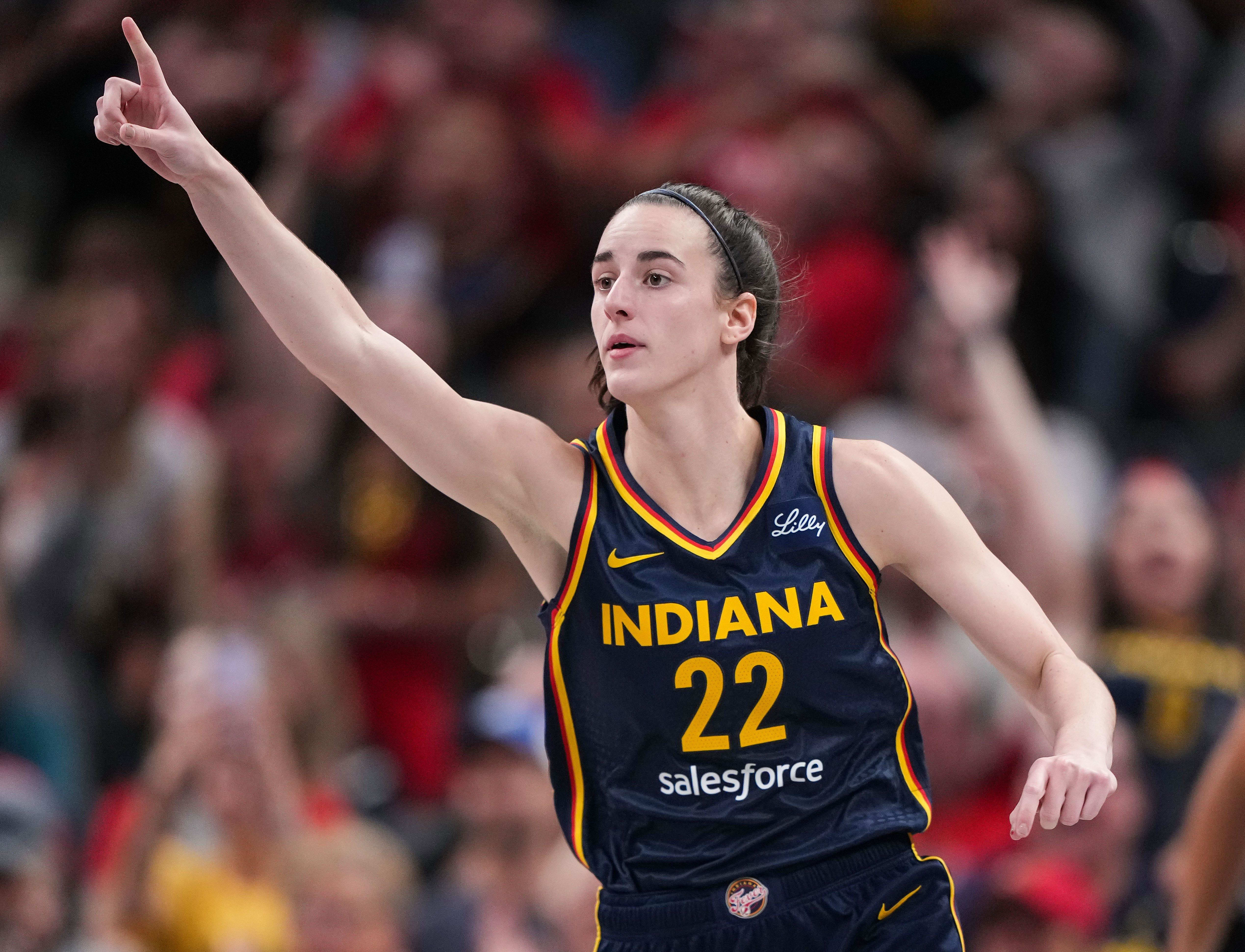 Indiana Fever guard Caitlin Clark rushes up the court during a game at Gainbridge Fieldhouse in Indianapolis.