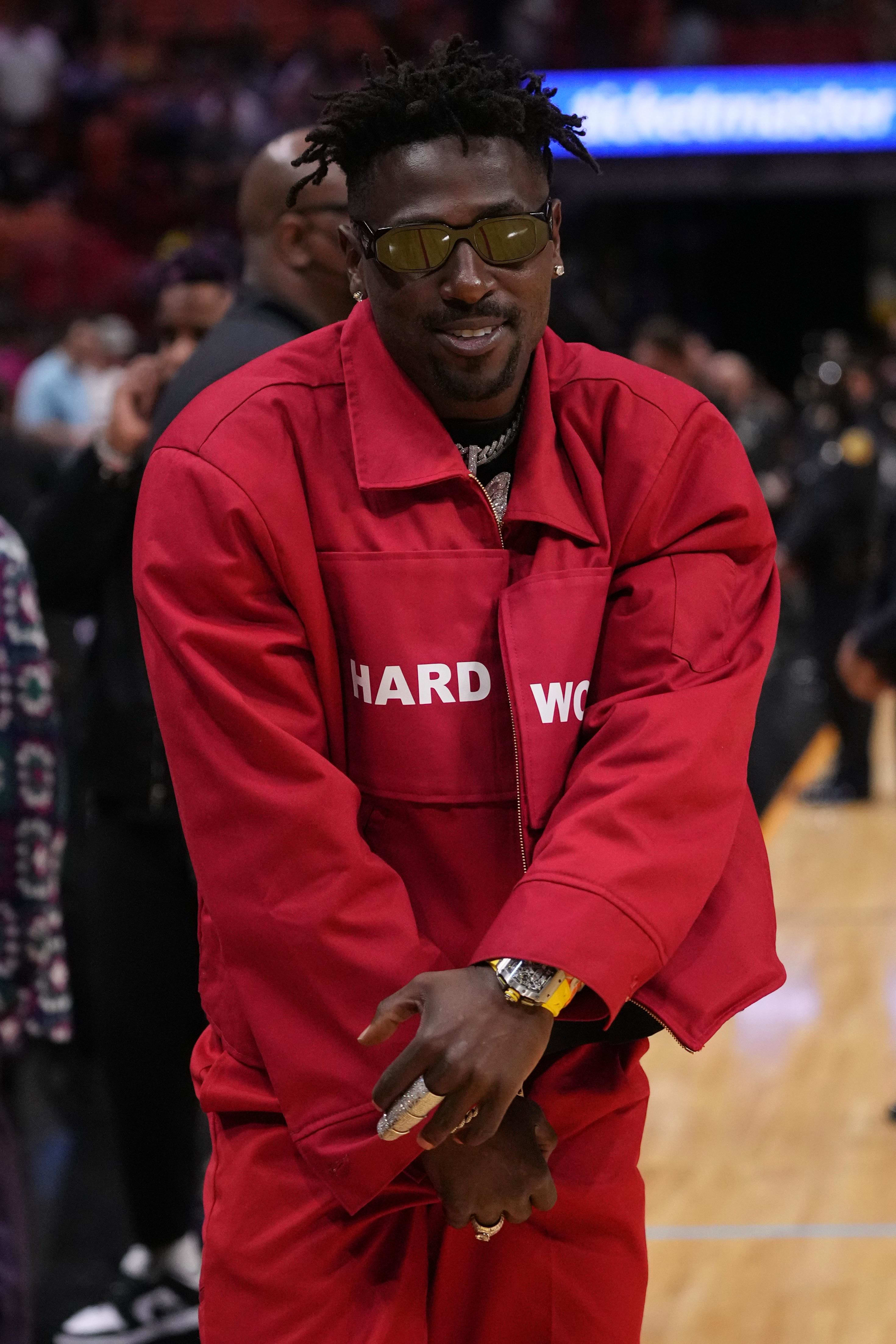 Former NFL player Antonio Brown stands on the court during halftime of the game between the Miami Heat and the Brooklyn Nets.