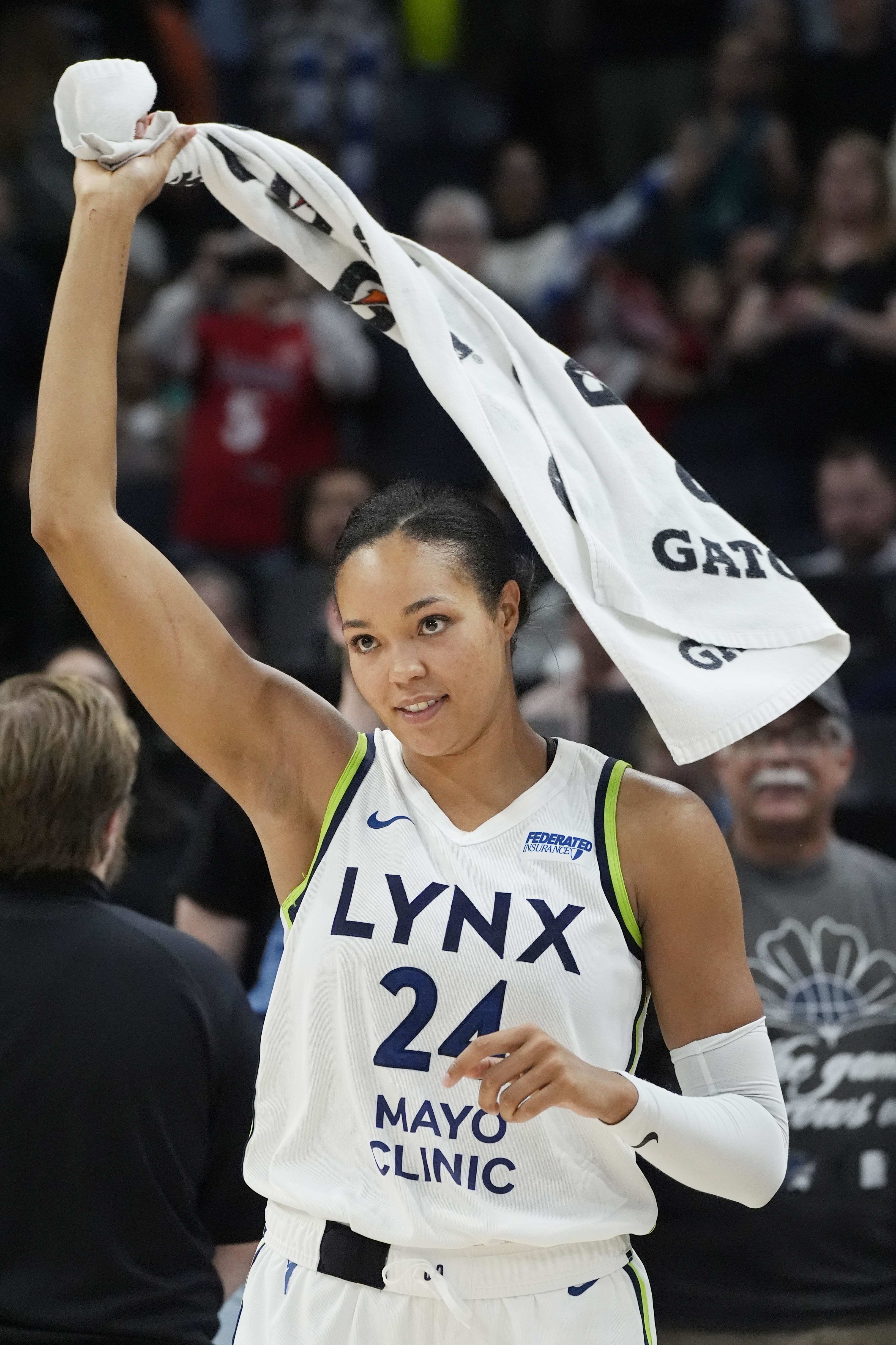 Minnesota Lynx forward Napheesa Collier waves a towel to celebrate the win over the Los Angeles Sparks.