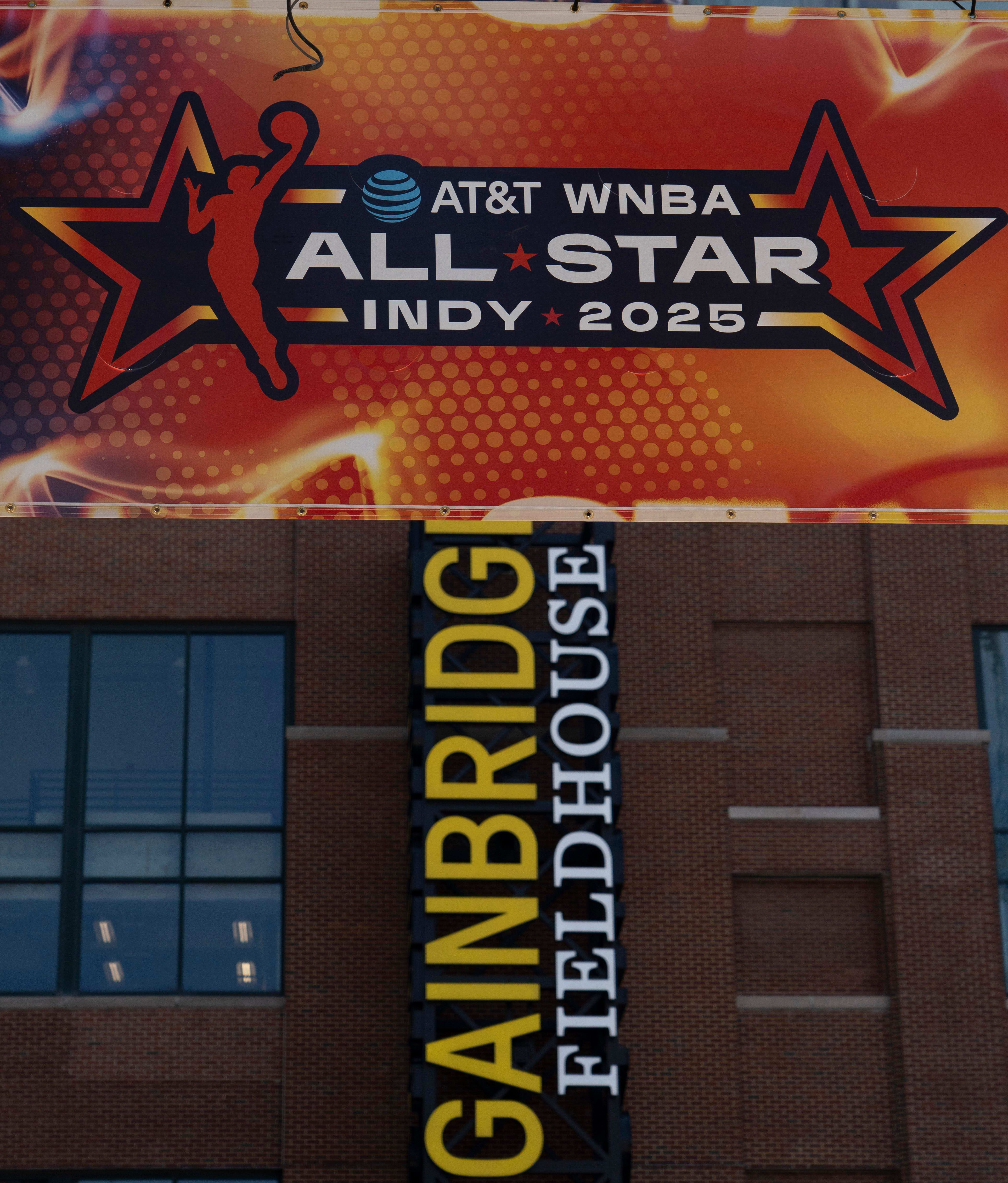 Signs advertising the WNBA All-Star games go up around Gainbridge Fieldhouse.