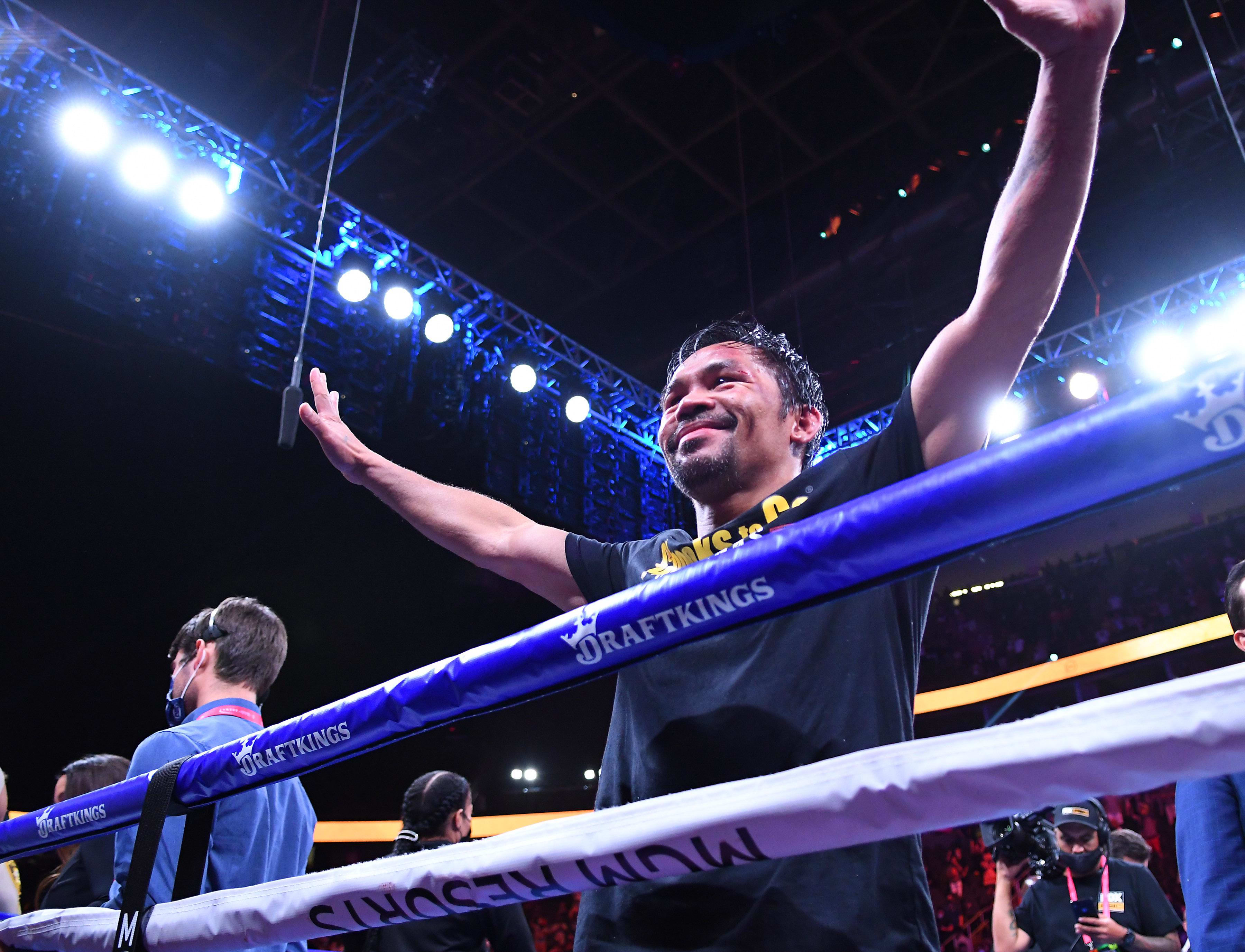 Manny Pacquiao waves to fans after losing in a world welterweight championship bout in a decision to Yordenis Ugas
