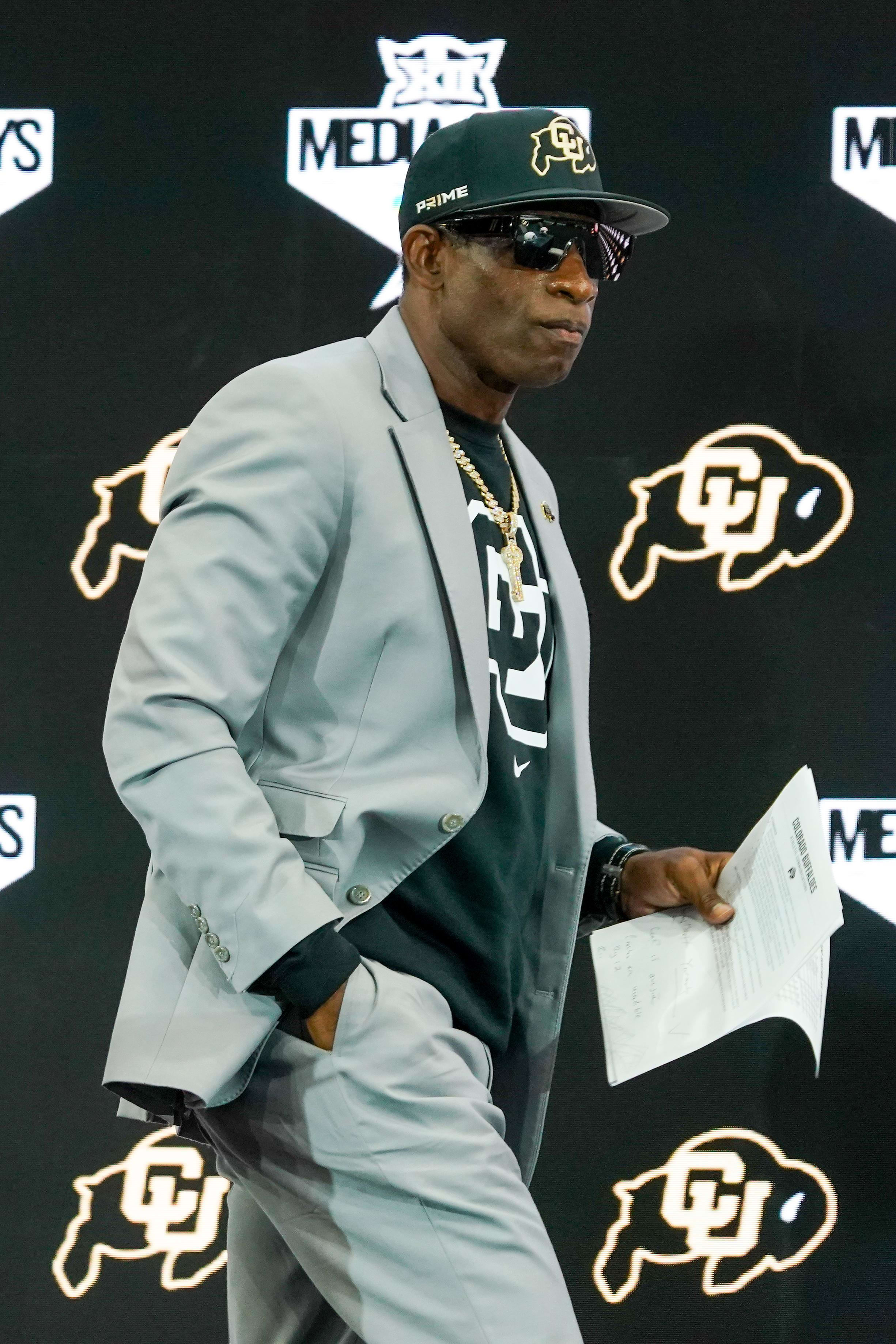 Colorado head coach Deion Sanders walks onto the stage during 2025 Big 12 Football Media Days at The Star. 