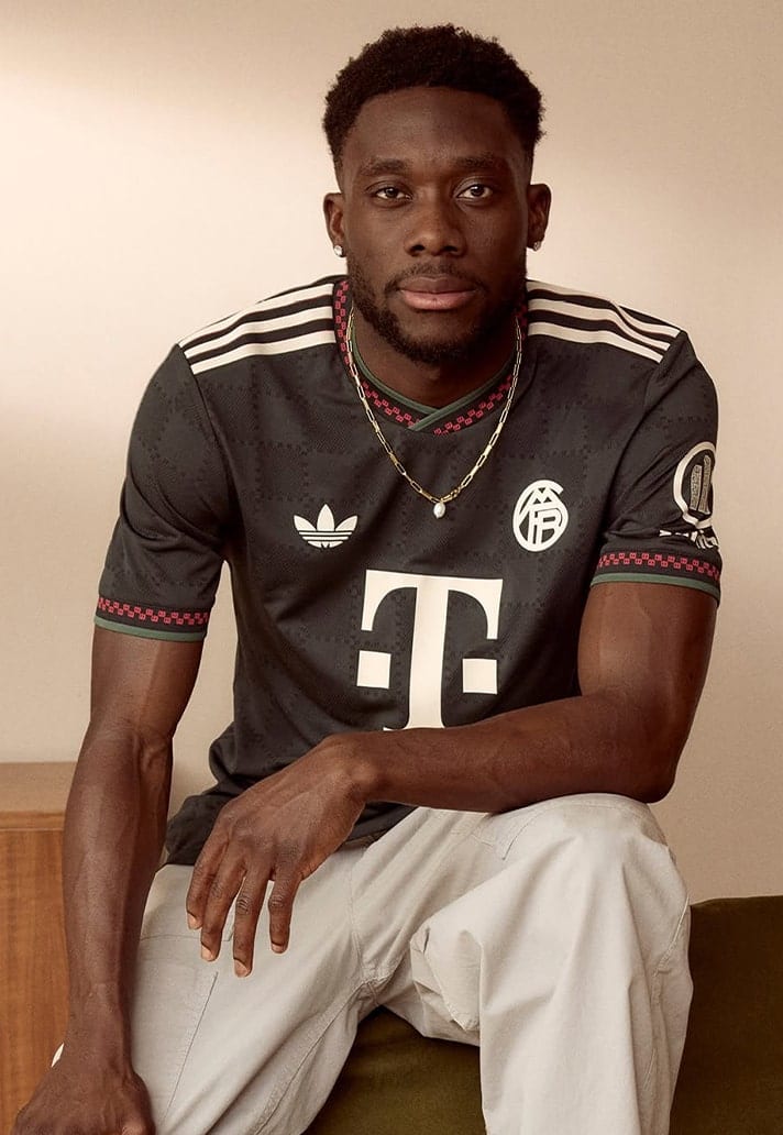 Alphonso Davies models Bayern's new third kit.