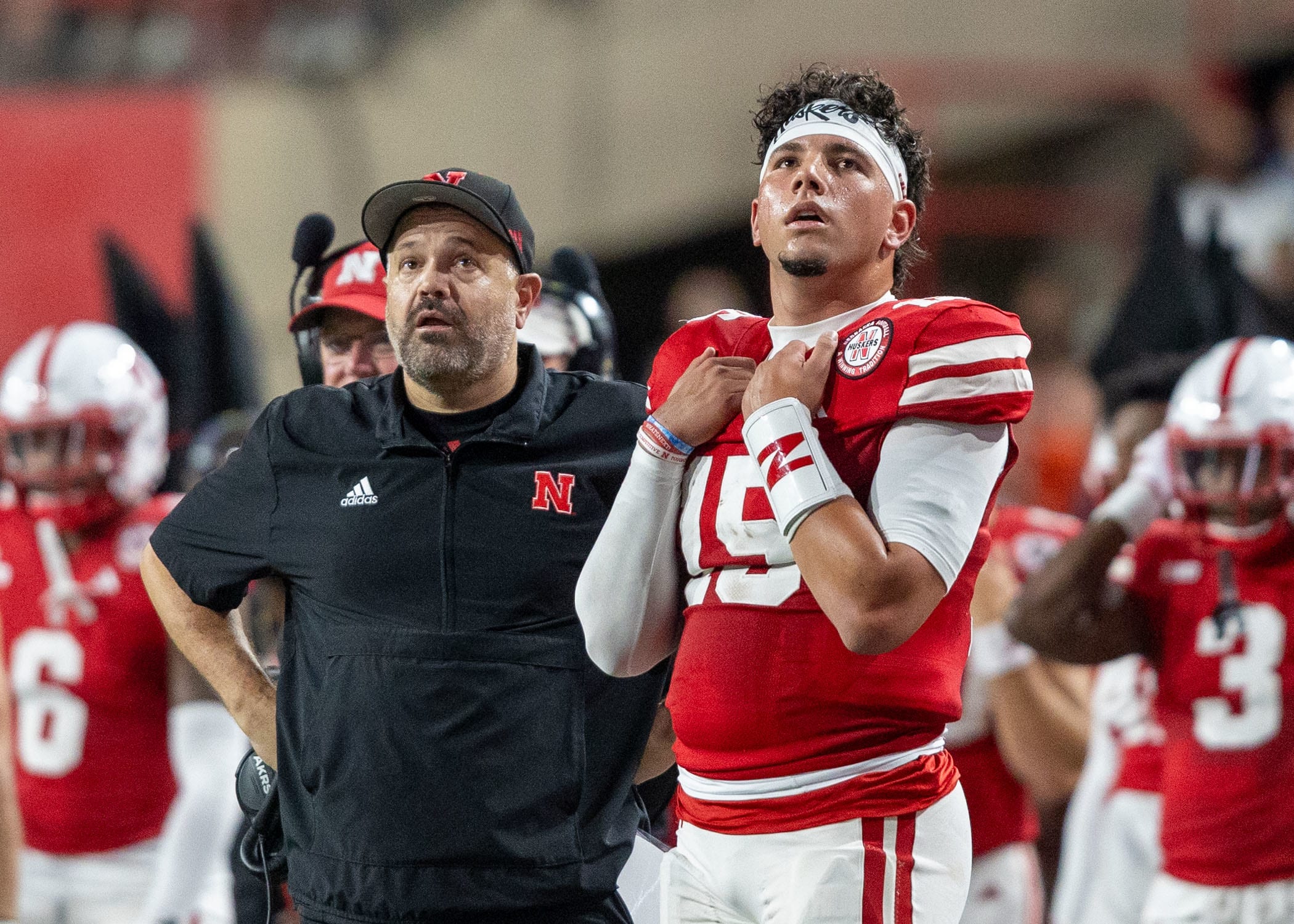 Nebraska Head Coach Matt Rhule and quarterback Dyaln Raiola look up at the scoreboard during the Illinois game.