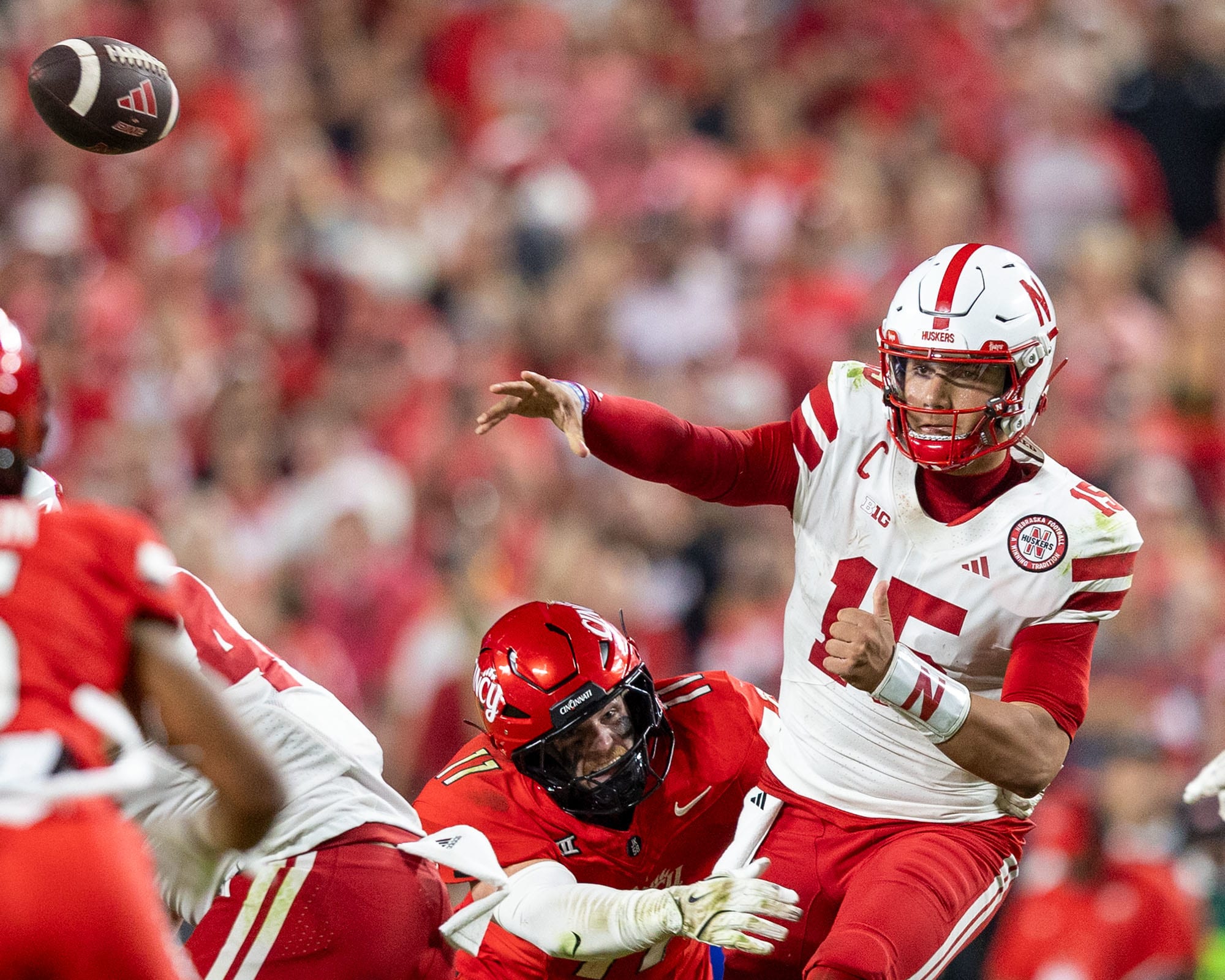 Nebraska quarterback Dylan Raiola fires a pass while facing pressure from Cincinnati's Jake Golday at Arrowhead Stadium in Ka