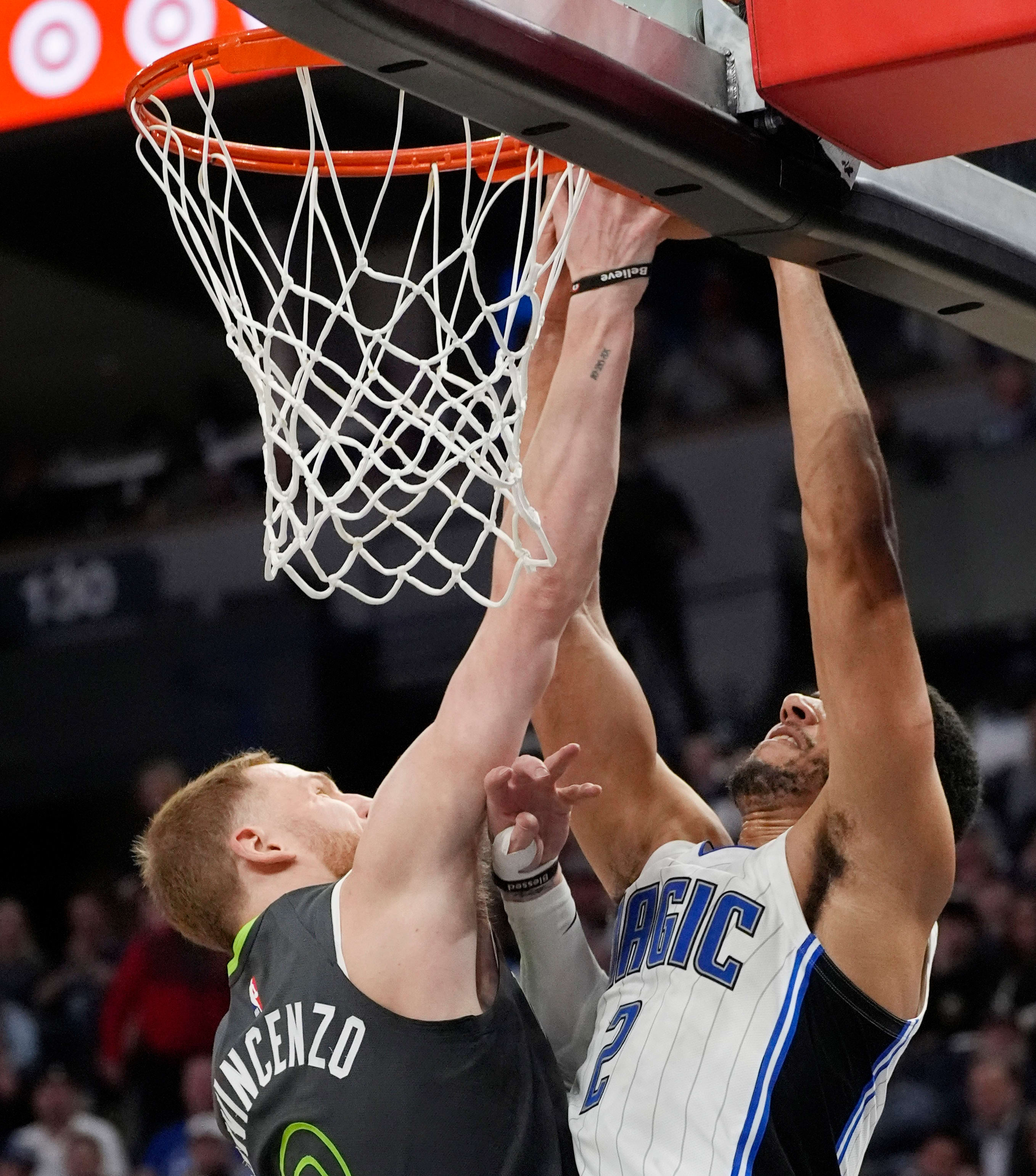Minnesota Timberwolves guard Donte DiVincenzo blocks a shot by Orlando Magic forward Caleb Houstan.